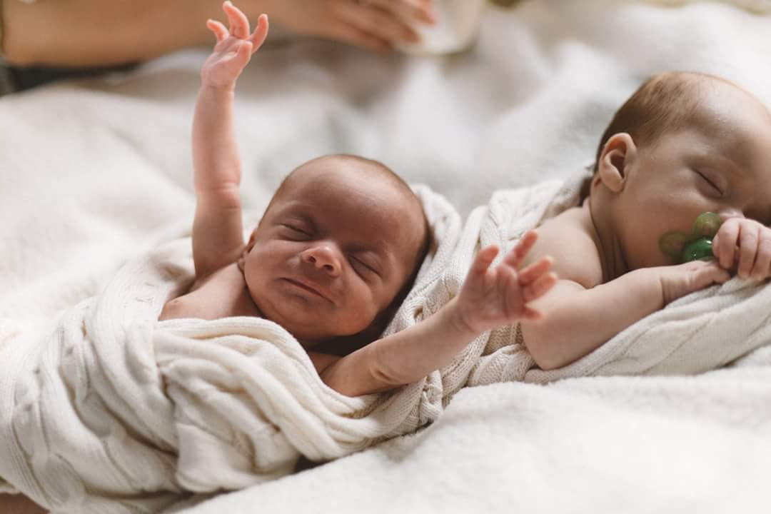 New born twins yawning and sleeping