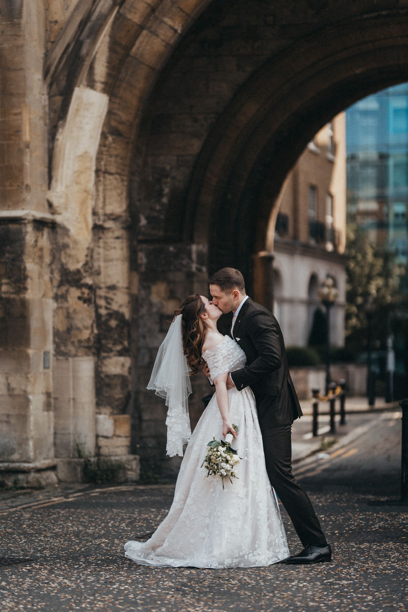 Happy newly wed couple outside Oxford Bodleian Library. Alternative confetti shot.