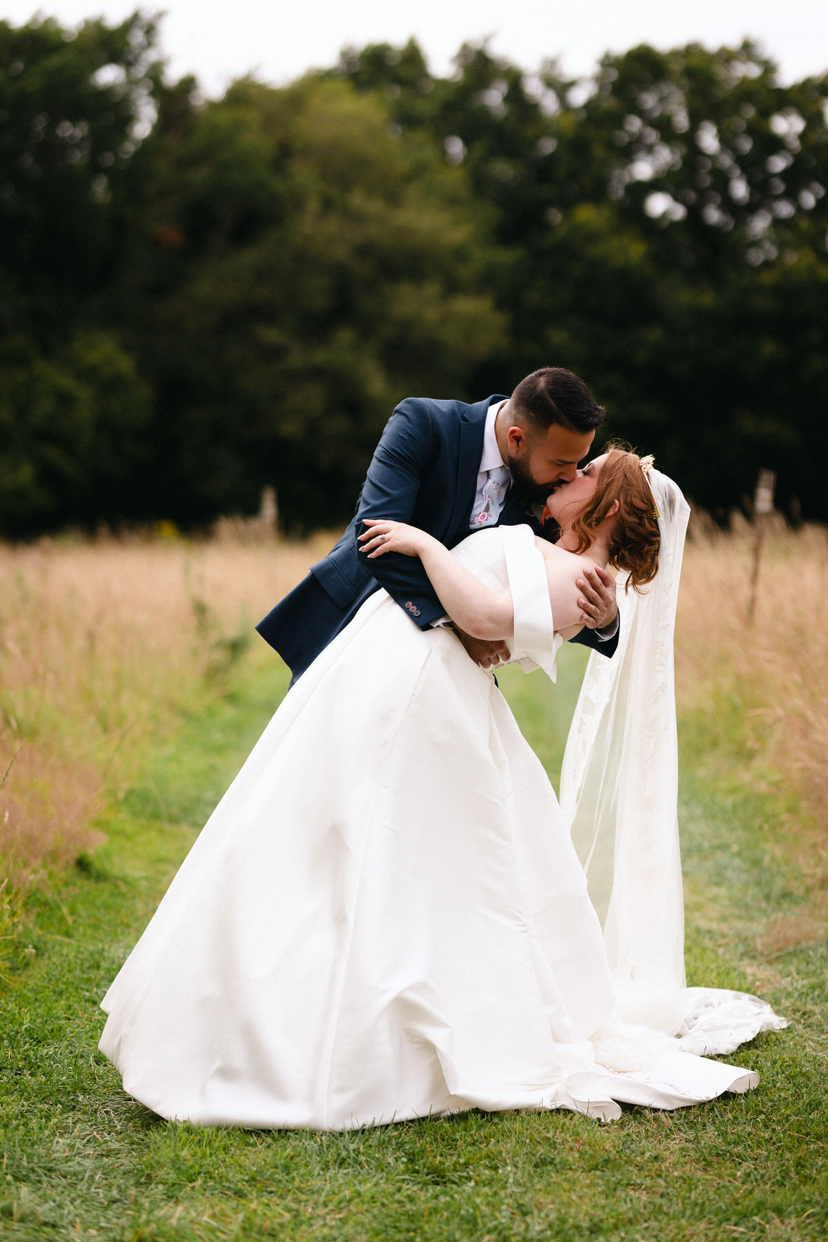 Bride and Groom at Alter in woodland setting kissing