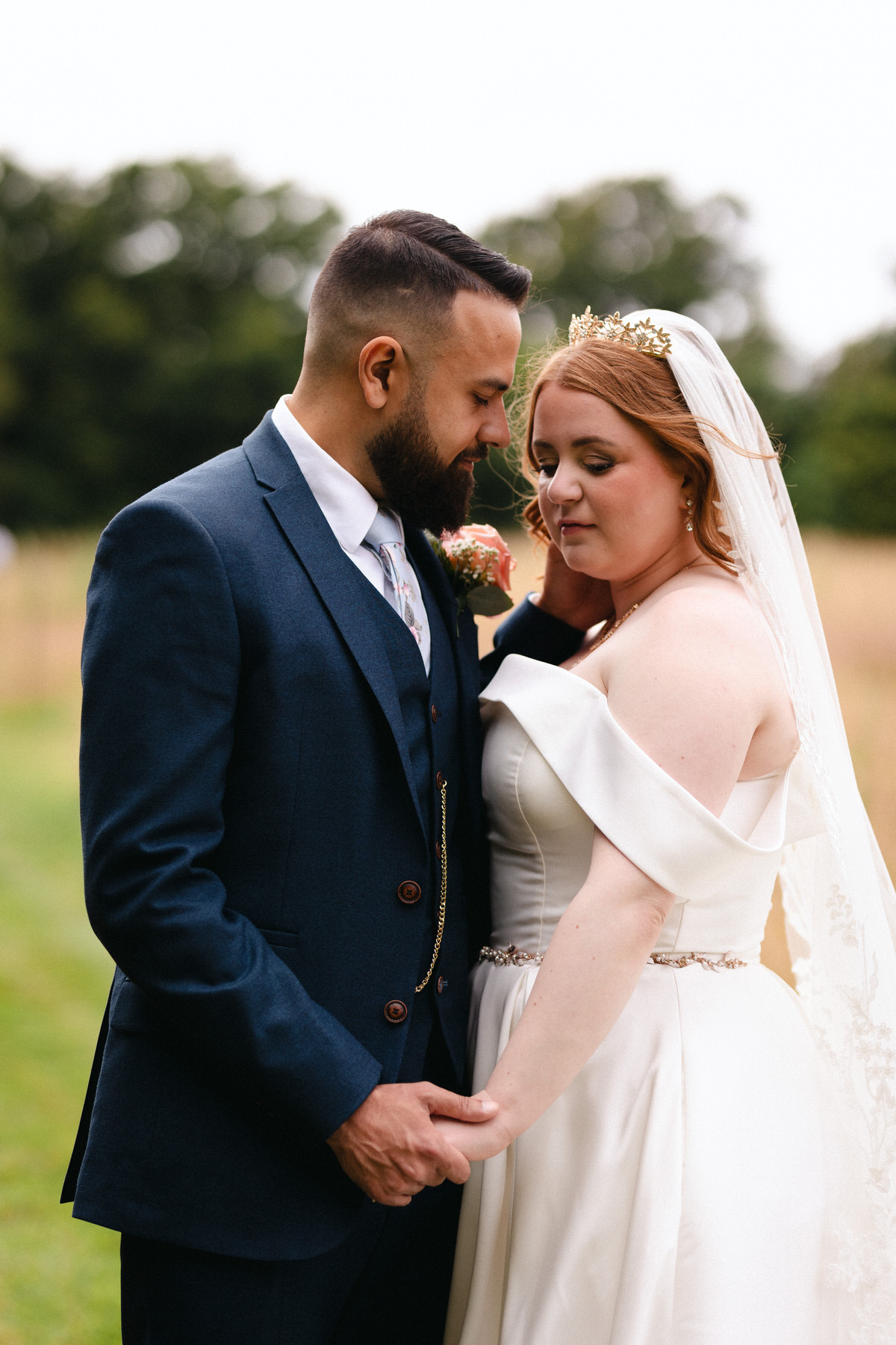 Black and white photo of bride and groom kissing. 