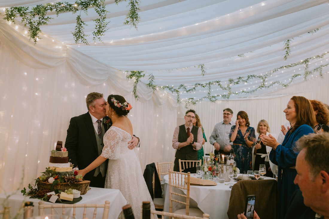 Bride and Groom dancing in a field at sunset golden hour