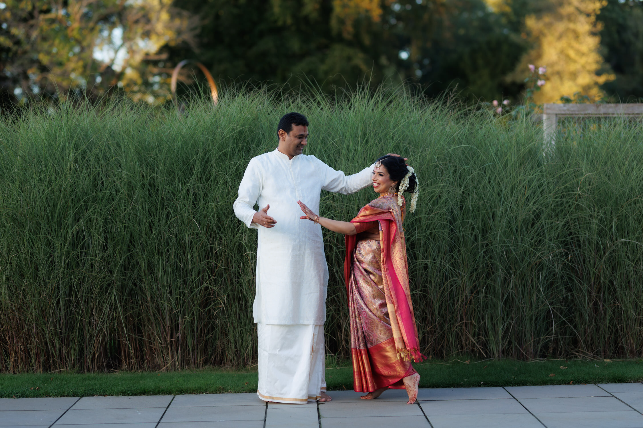 Indian wedding couple lady in red sari man in suit smiling