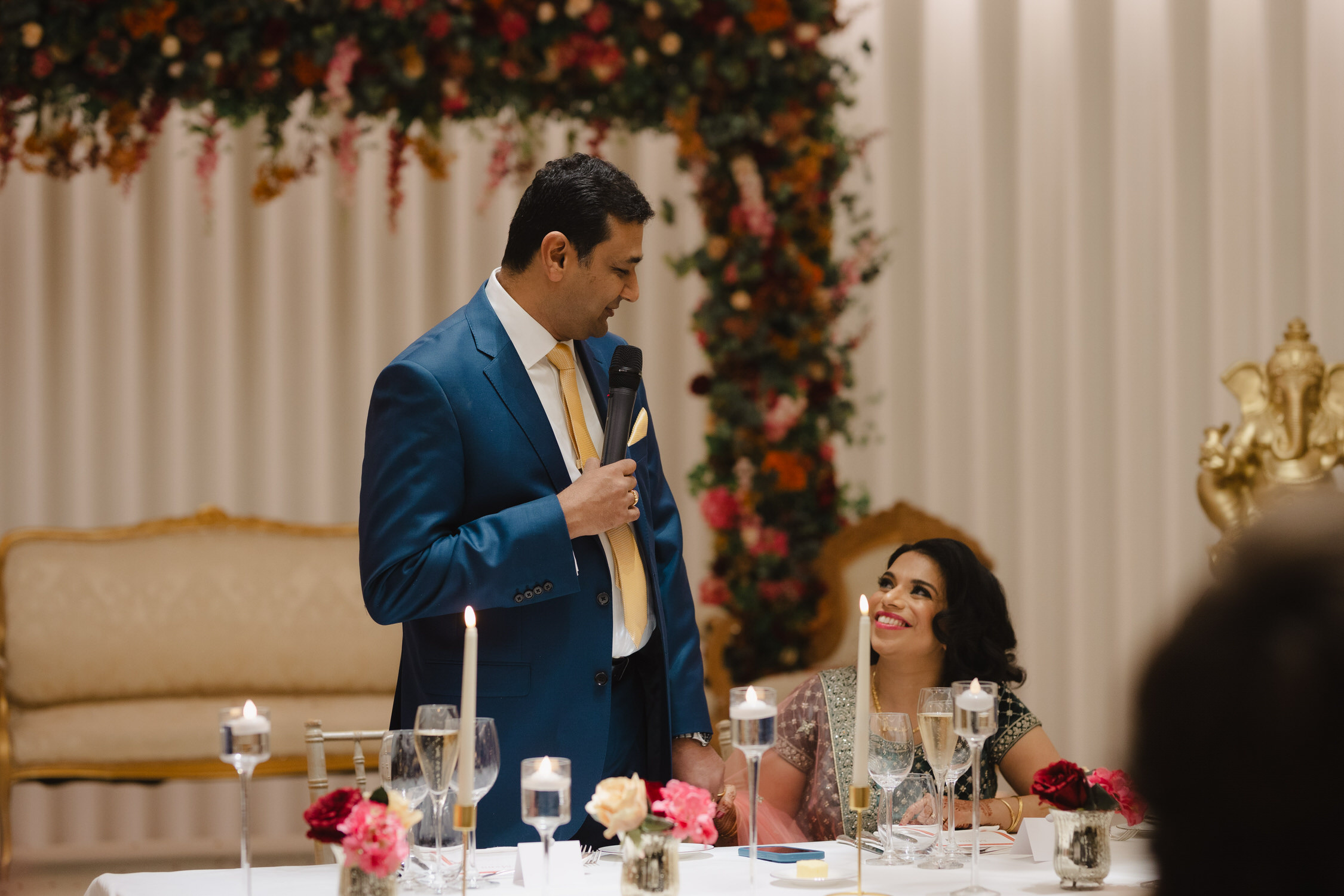 Indian wedding couple lady in red sari man in suit smiling